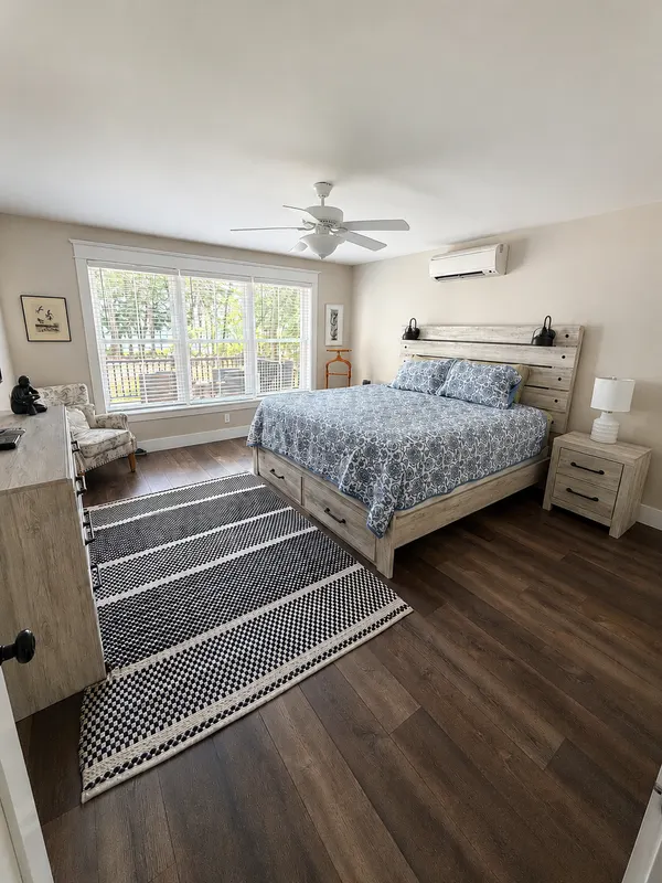 Master bedroom with a king-size bed dressed in blue bedding