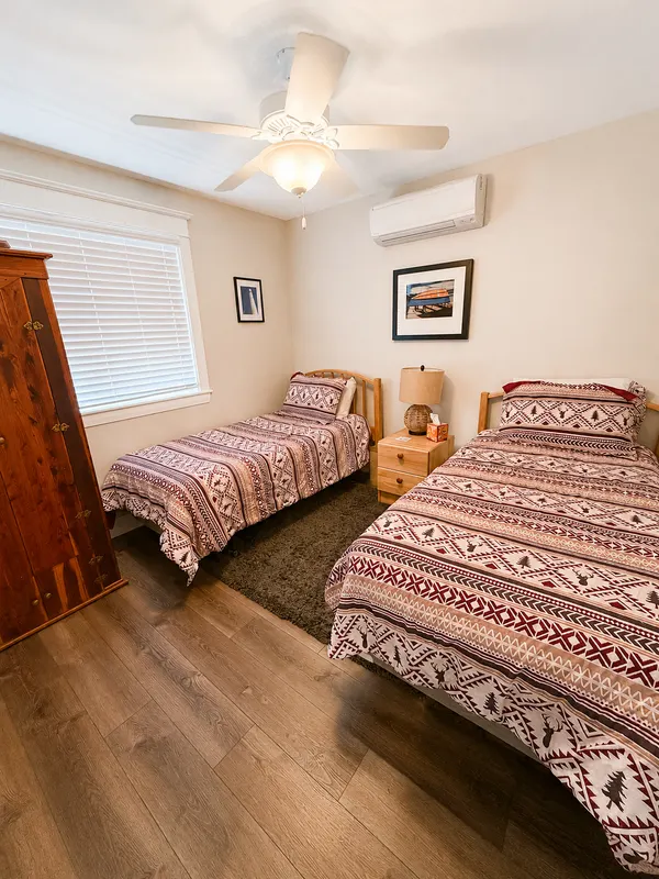 Guest bedroom with twin beds and maroon patterned comforters