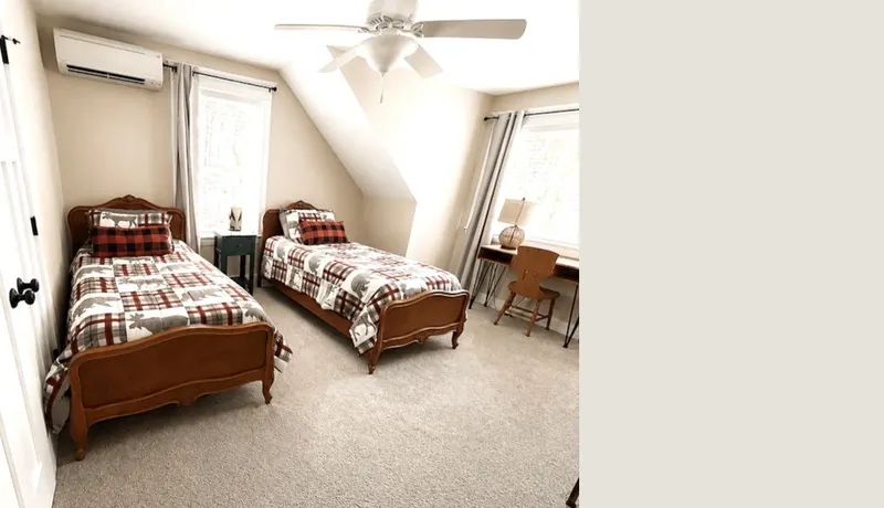 Second-floor guest bedroom with two twin beds dressed in plaid bedding