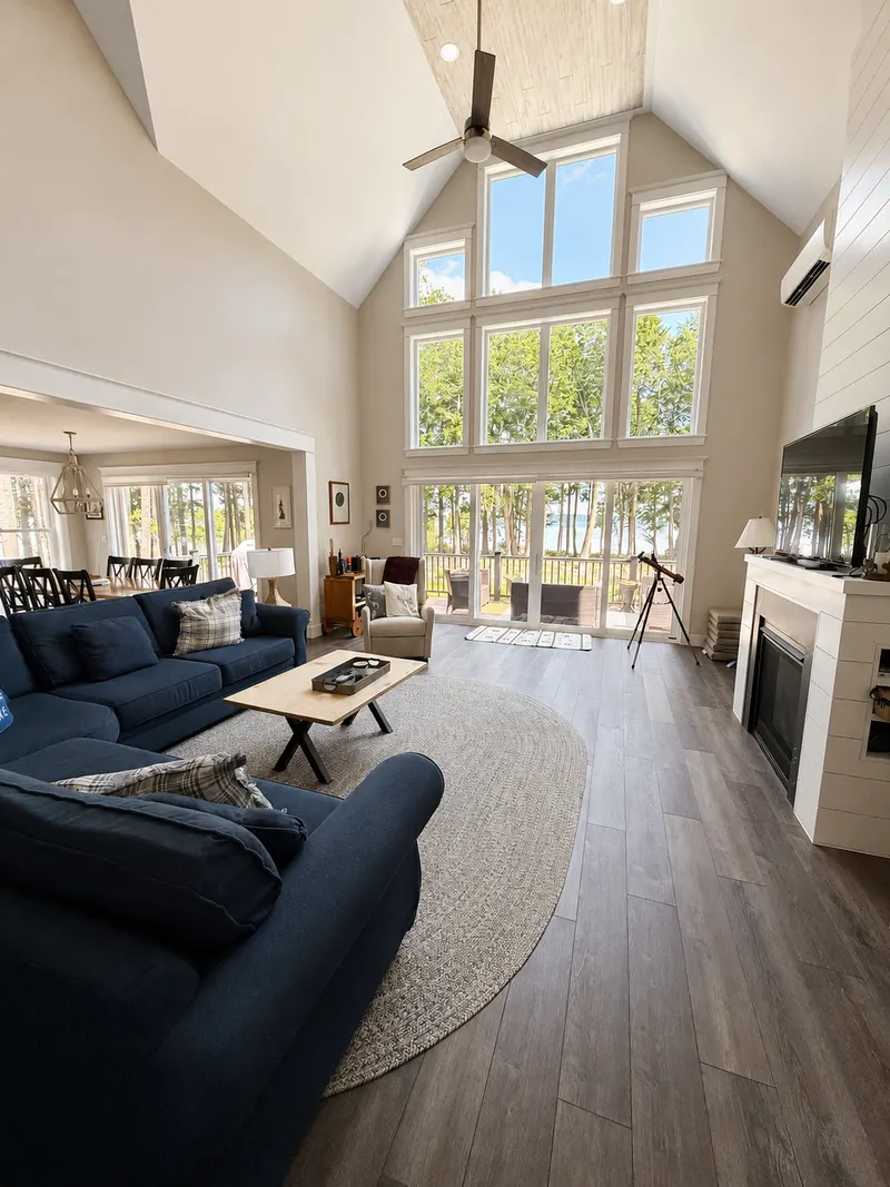 Living room with floor-to-ceiling windows overlooking the lake